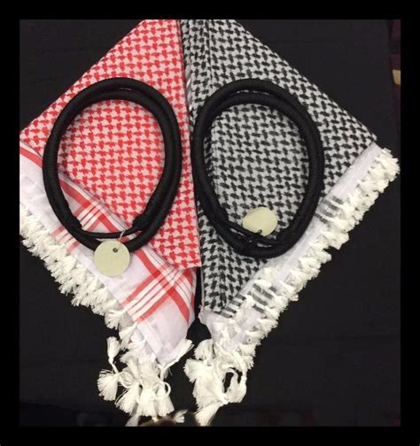 Black cord fastened around Arab headdress the keffiyeh .